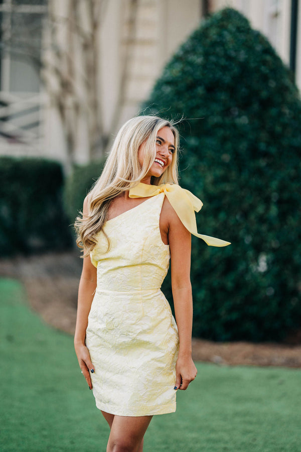 Pretty stylish woman wearing yellow and white polka-dot sundress and  sunglasses. Beautiful girl in long dress walking and standing at city  street Stock Photo | Adobe Stock